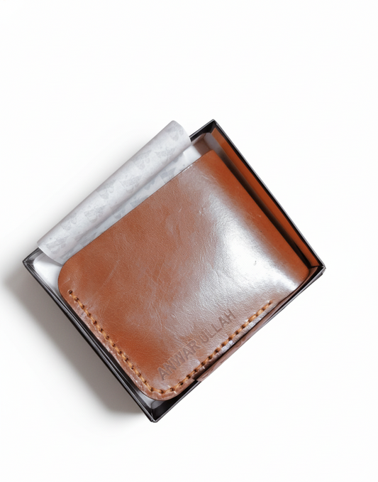 Brown leather wallet in a clear box on a white background