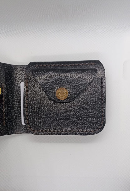 Black leather wallet with a gold button on a light gray background
