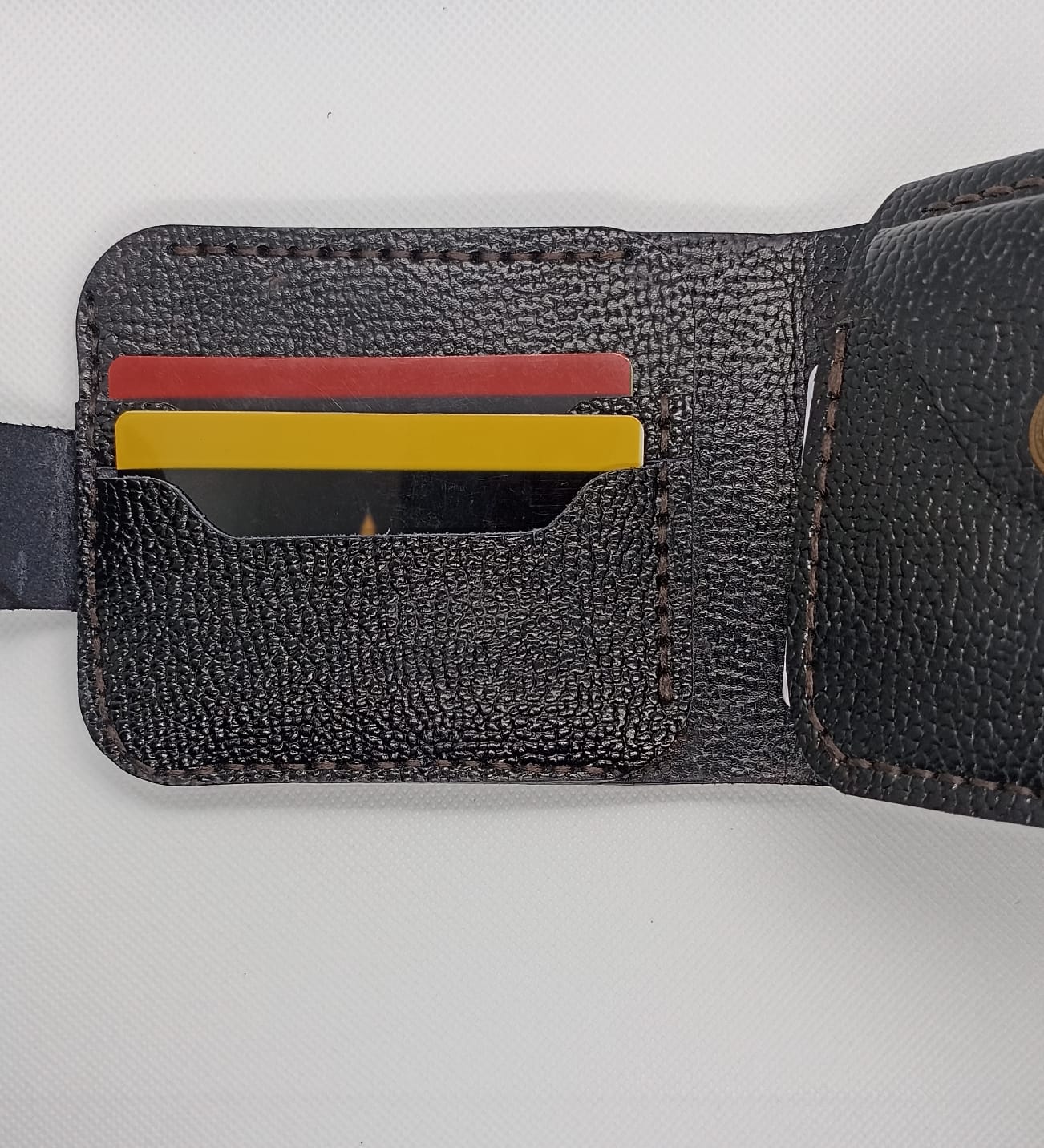 Black textured wallet with card slots on a white background