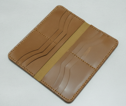 Brown leather cardholder on a light gray background
