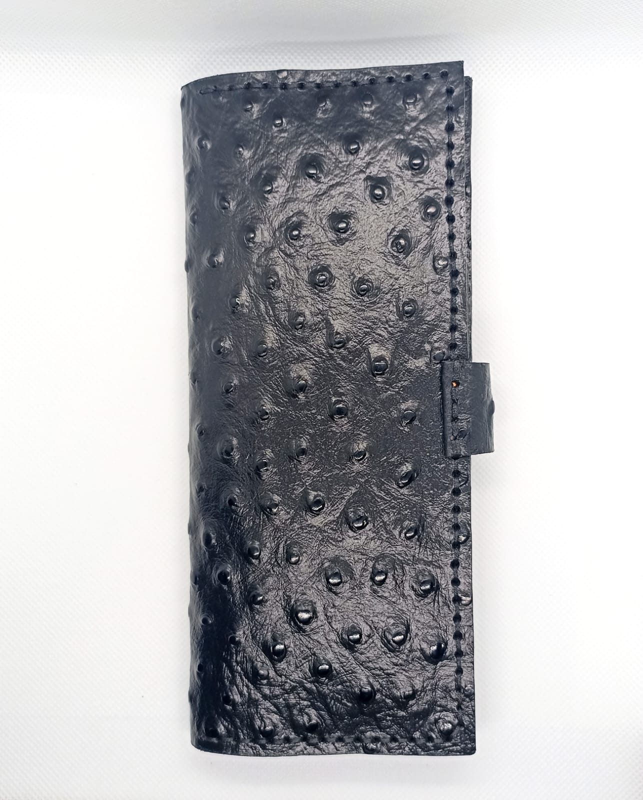 Black textured leather wallet on a white background