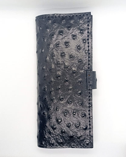 Black textured leather wallet on a white background