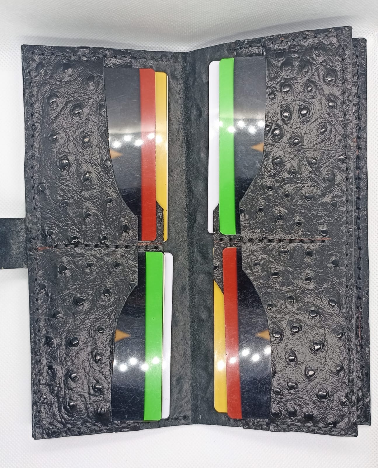 Decorative case with embossed design and colorful stripes on a white background