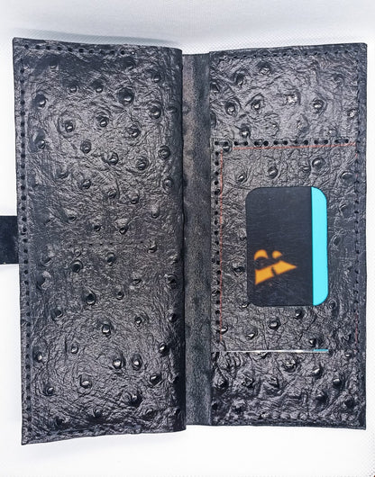 Black textured wallet with card holder on a white background